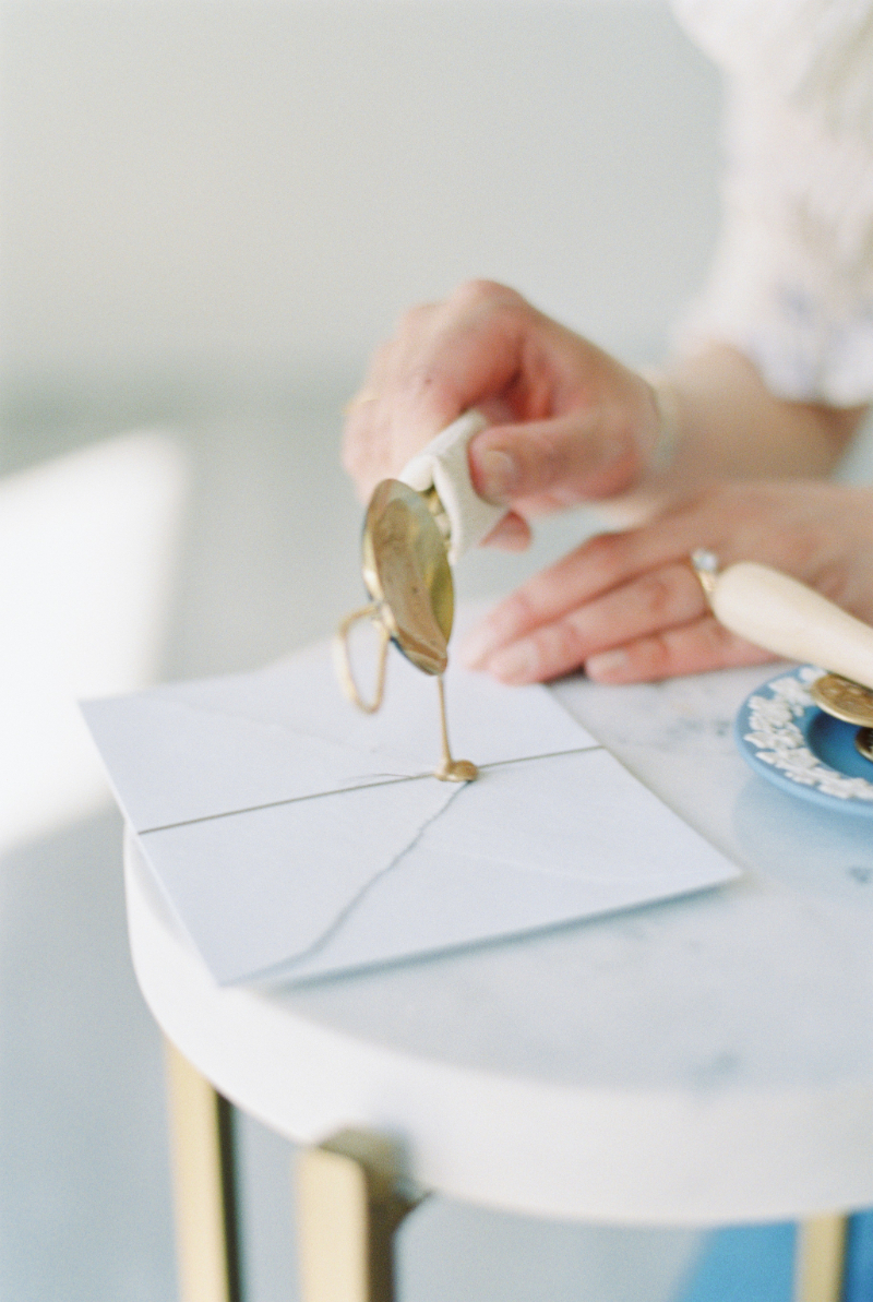 pouring wax seal on wedding invitations
